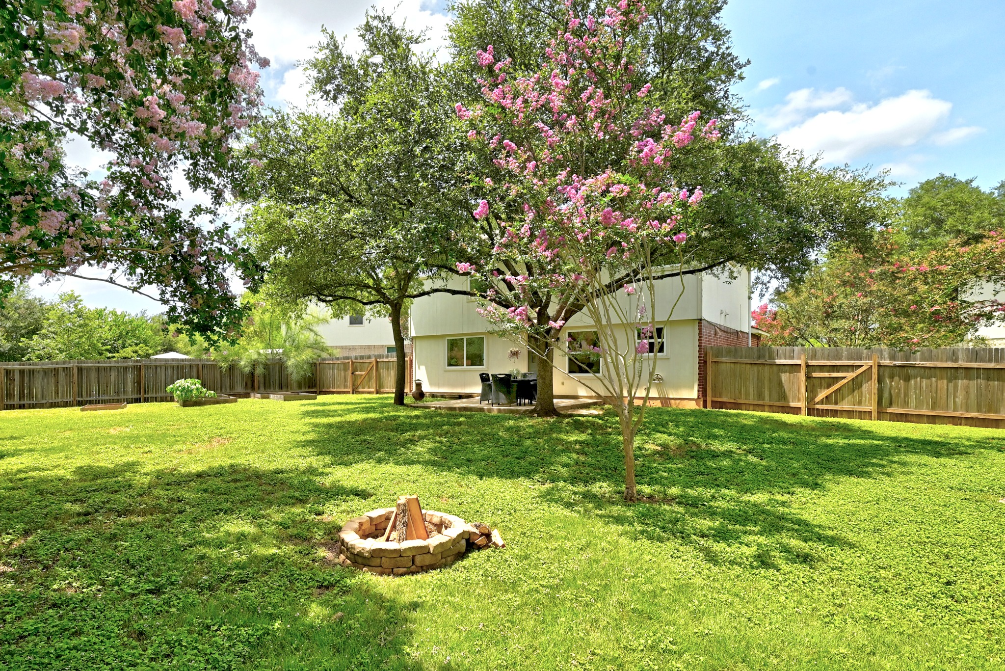 1801 Monks Tale Court Austin, TX 78748 - Photo 23 of 36 A spacious backyard with mature trees and a charming fire pit creates an inviting outdoor retreat.