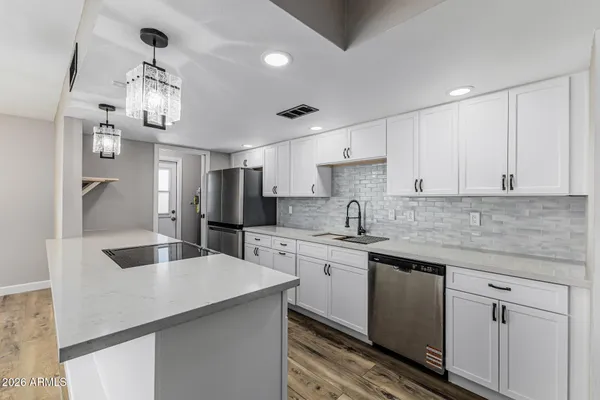 a kitchen with a center island appliances and cabinets