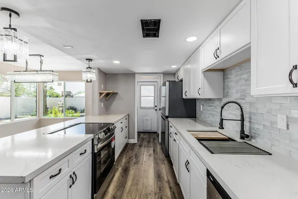 a kitchen with a sink stove and refrigerator