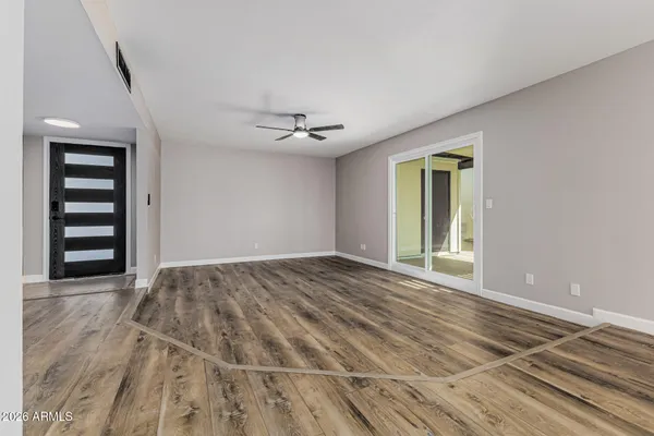 a view of an empty room with a window and closet