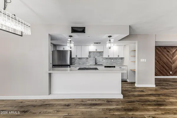 a kitchen with kitchen island sink stove and refrigerator