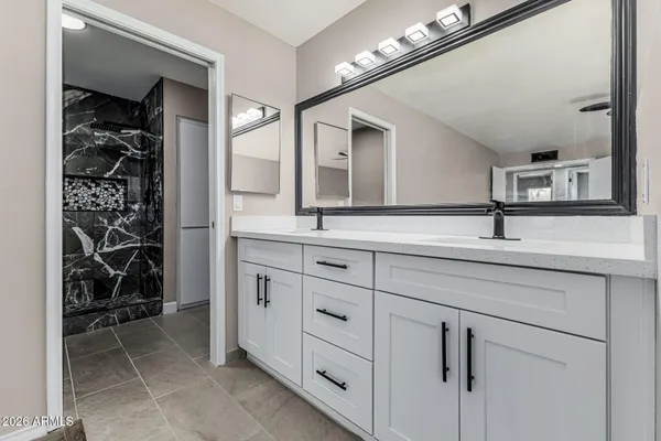 a bathroom with a sink a vanity and a mirror