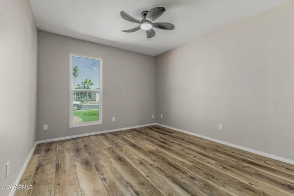 wooden floor in an empty room with a window