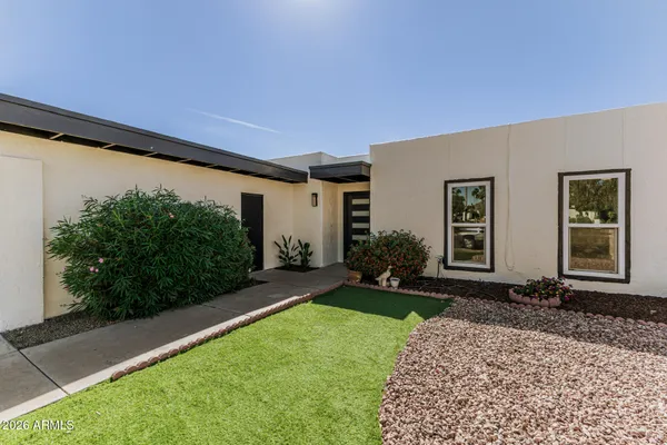 a front view of a house with garden