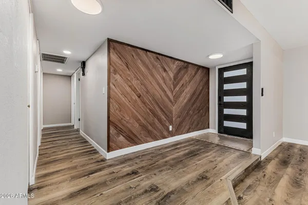 a view of a livingroom with wooden floor and closet