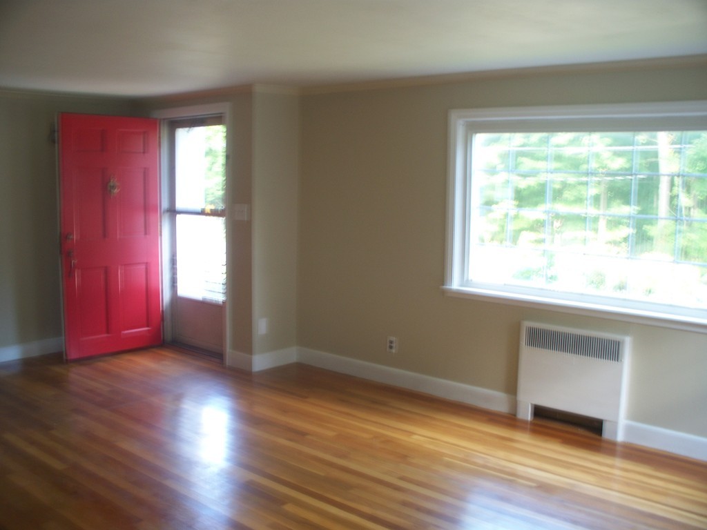 23 Summer Road Boxborough, MA 01719 - Photo 6 of 14 a view of an empty room with wooden floor and a window