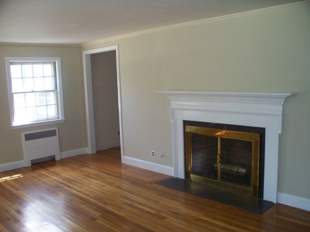 23 Summer Road Boxborough, MA 01719 - Photo 8 of 14 an empty room with wooden floor fireplace and windows