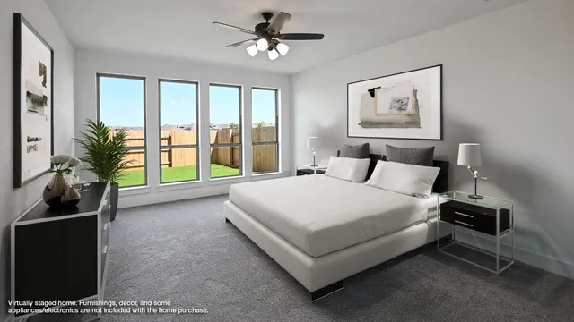 a bedroom with a bed a ceiling fan and a window