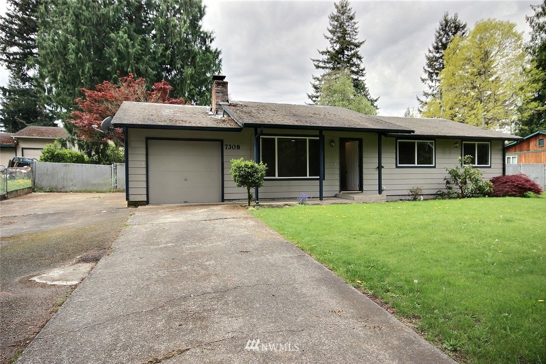 7308 Vandermark Road East Bonney Lake, WA 98391 - Photo 1 of 30 a front view of a house with a garden and trees