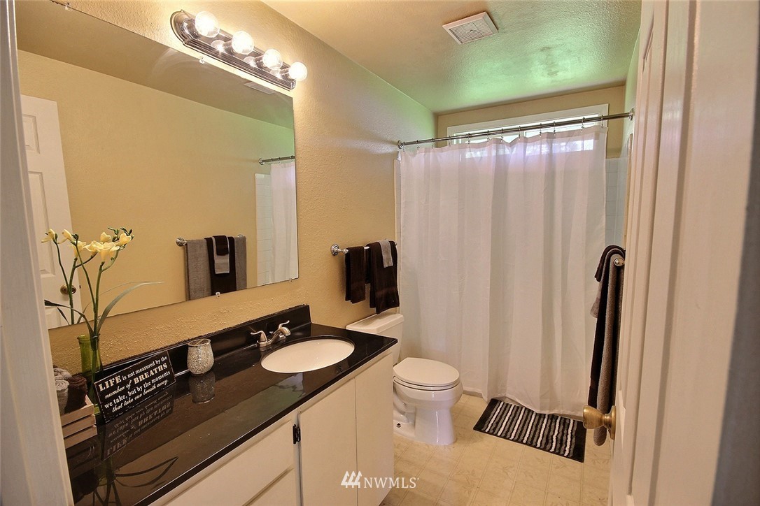 7308 Vandermark Road East Bonney Lake, WA 98391 - Photo 11 of 30 a bathroom with a granite countertop sink toilet and shower