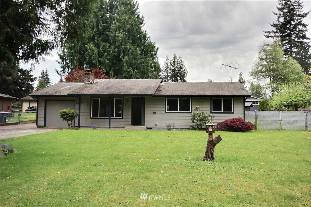7308 Vandermark Road East Bonney Lake, WA 98391 - Photo 14 of 30 a front view of a house with a yard and a tree