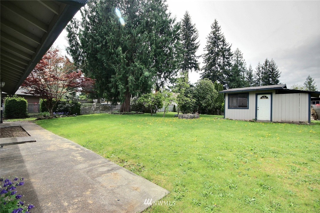 7308 Vandermark Road East Bonney Lake, WA 98391 - Photo 16 of 30 a view of a backyard with a garden
