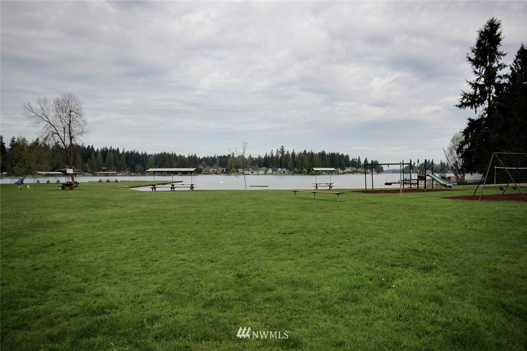 7308 Vandermark Road East Bonney Lake, WA 98391 - Photo 22 of 30 a view of a lake with houses in the back