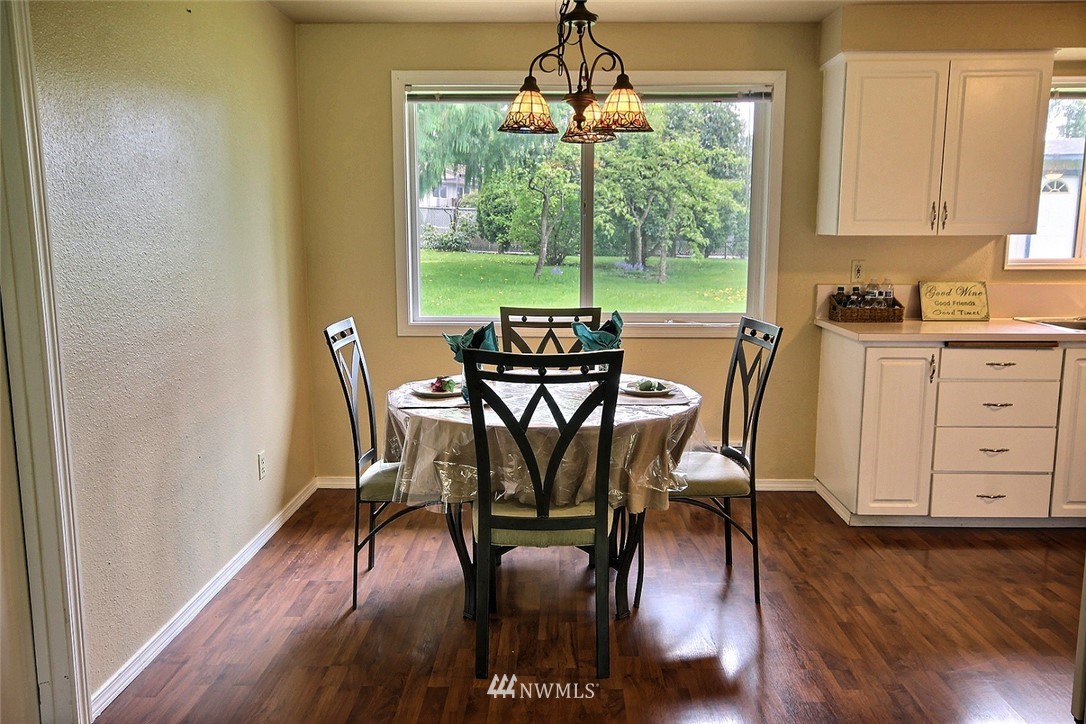 7308 Vandermark Road East Bonney Lake, WA 98391 - Photo 4 of 30 a view of a dining room with furniture window and wooden floor