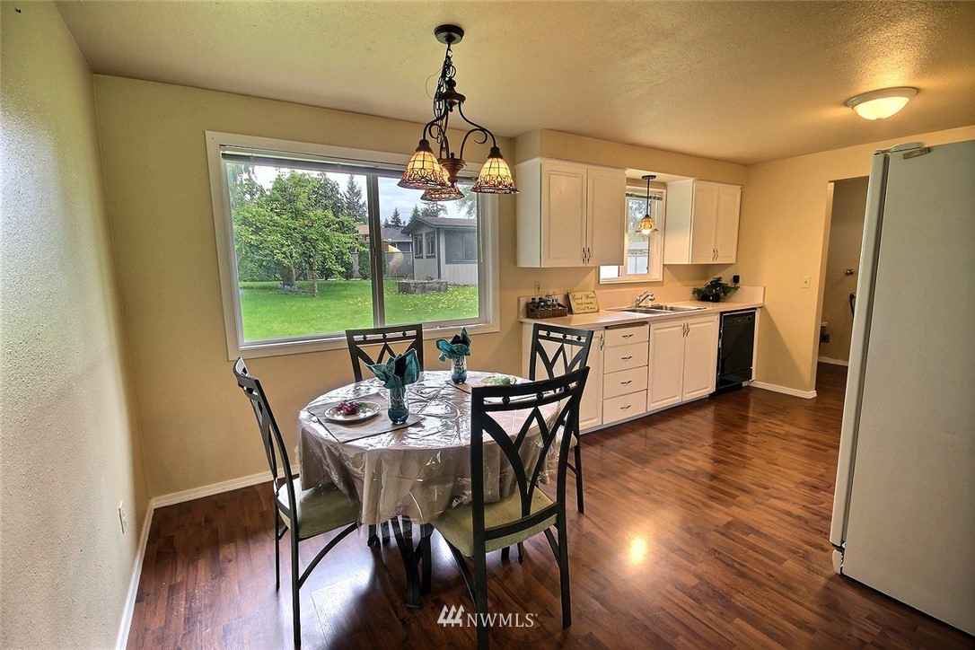 7308 Vandermark Road East Bonney Lake, WA 98391 - Photo 5 of 30 a view of a dining room with furniture window and wooden floor