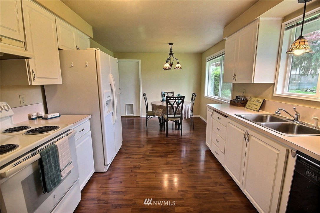 7308 Vandermark Road East Bonney Lake, WA 98391 - Photo 7 of 30 a kitchen with a sink stove and refrigerator