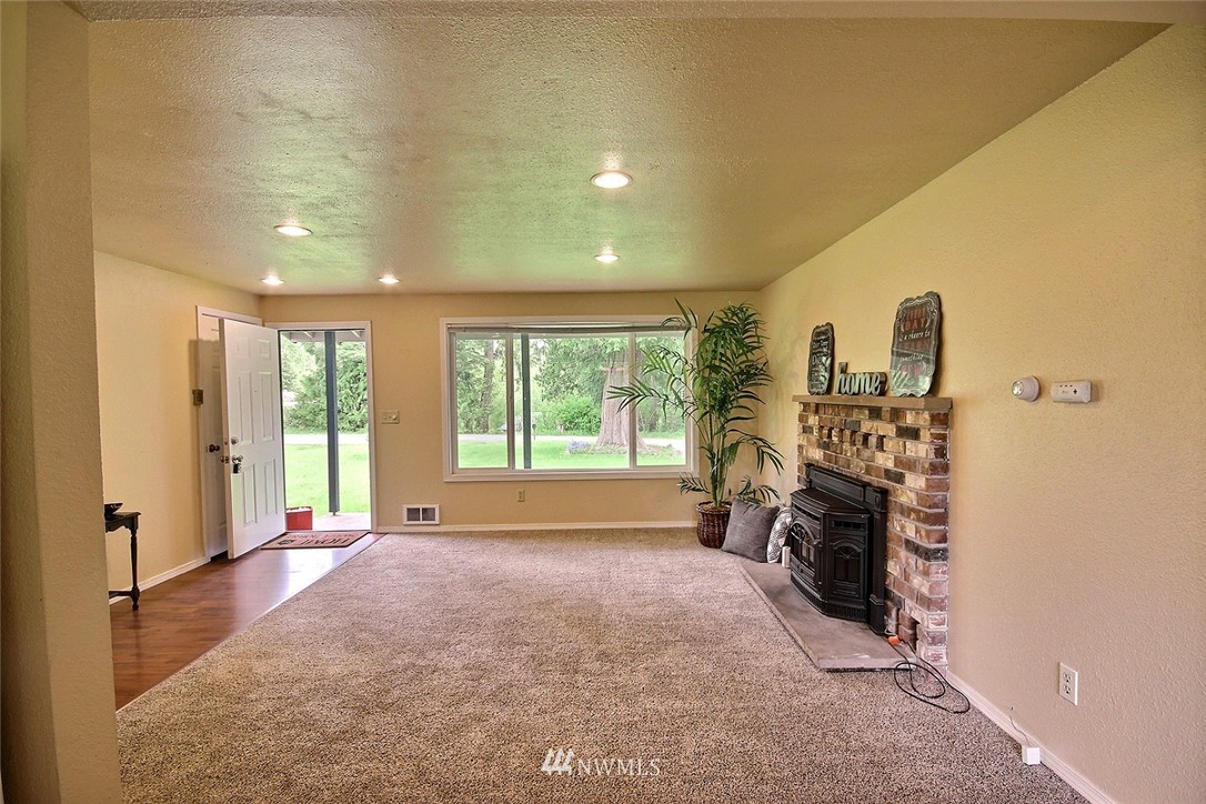 7308 Vandermark Road East Bonney Lake, WA 98391 - Photo 8 of 30 a living room with furniture and a fireplace