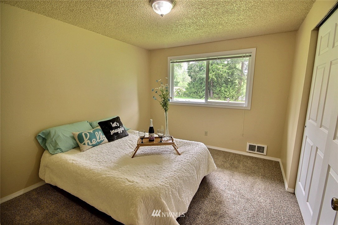 7308 Vandermark Road East Bonney Lake, WA 98391 - Photo 10 of 30 a bedroom with a bed and a window