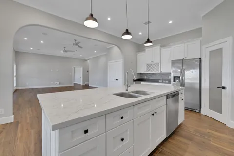 a kitchen with white cabinets and refrigerator