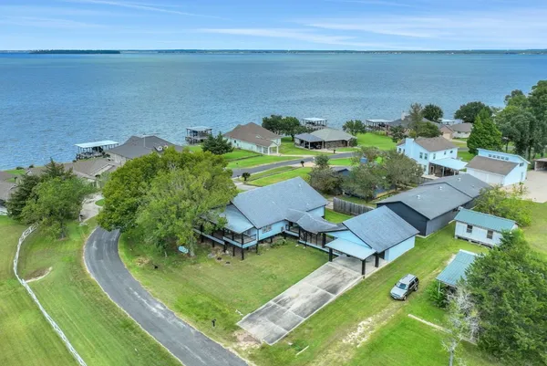 an aerial view of a house with garden space and outdoor seating