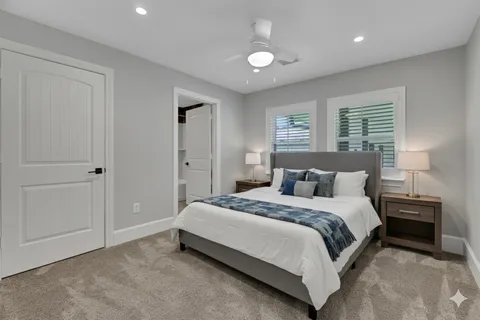 an empty room with closet and a ceiling fan