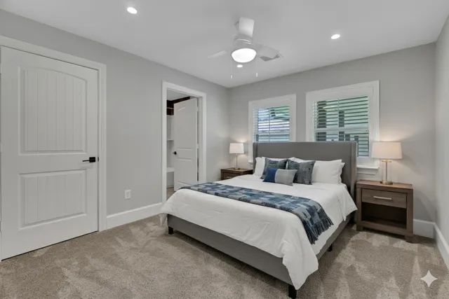 an empty room with closet and a ceiling fan