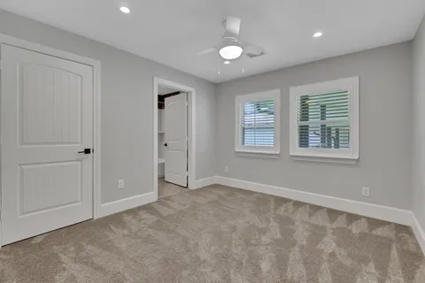 a bathroom with a granite countertop sink mirror toilet and bathtub