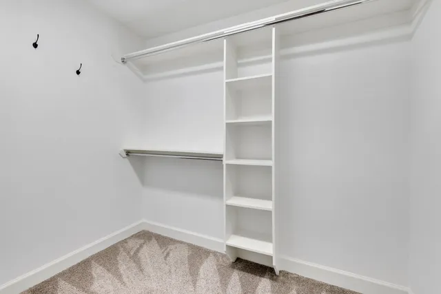 a bedroom with a bed and a lamp