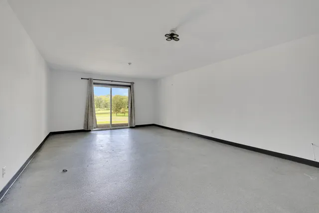a view of a livingroom with furniture and staircase