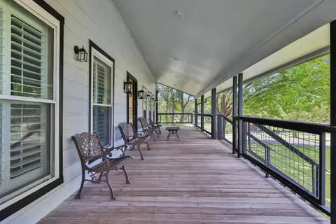 a view of two chairs in the balcony