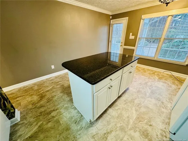 a kitchen with granite countertop cabinets and a stove