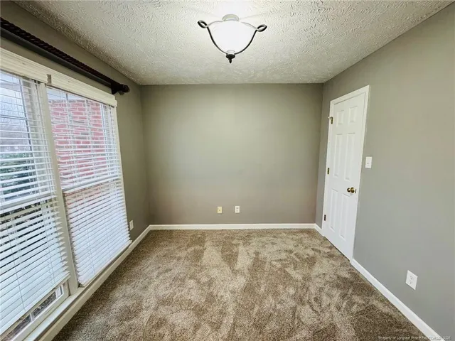 a view of a room with window and a ceiling fan
