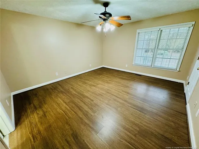 wooden floor in an empty room with a window