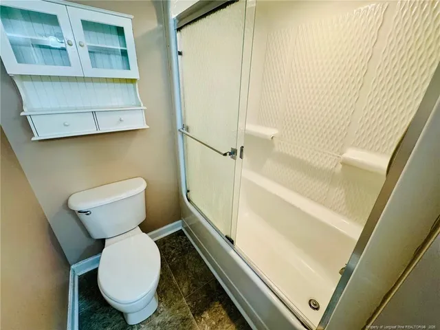 a view of closet with wooden floor