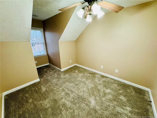 a view of a porch and a yard with wooden fence