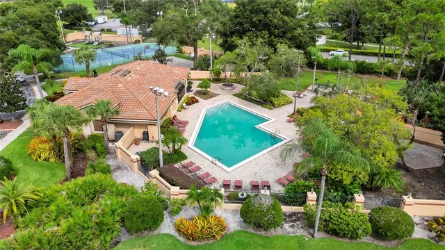 an aerial view of a house with garden space and street view