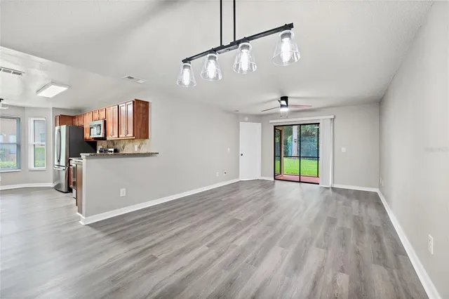 a view of a kitchen with a sink and dishwasher wooden floor