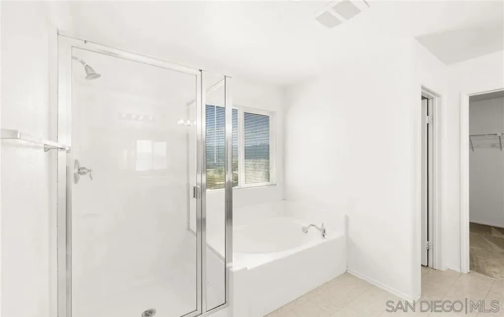 46197 Via La Tranquila Temecula, CA 92592 - Photo 11 of 20 a bathroom with a bathtub and a shower