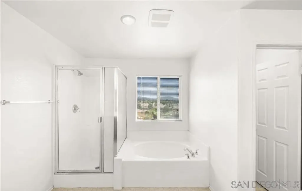 46197 Via La Tranquila Temecula, CA 92592 - Photo 15 of 20 a bathroom with a bathtub and a shower