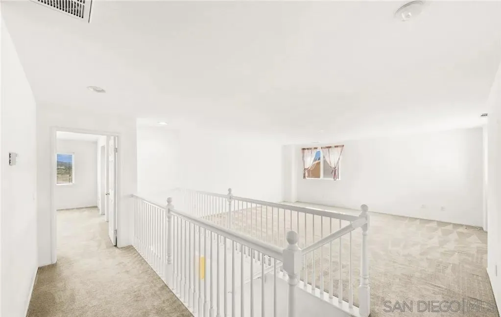 46197 Via La Tranquila Temecula, CA 92592 - Photo 20 of 20 a view of a hallway with wooden floor and windows