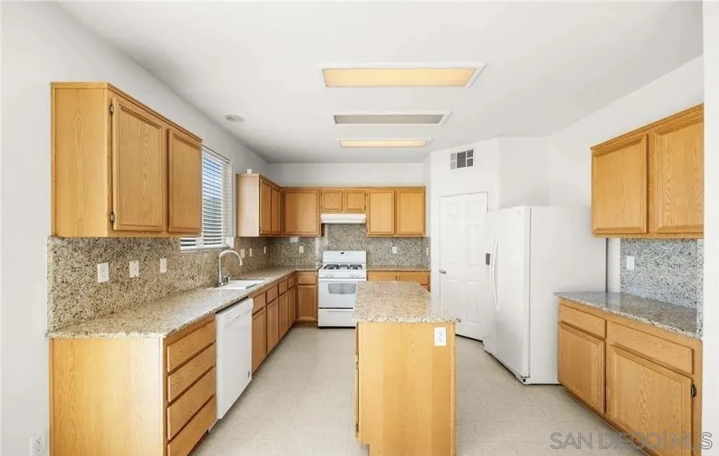 46197 Via La Tranquila Temecula, CA 92592 - Photo 4 of 20 a large white kitchen with a large window
