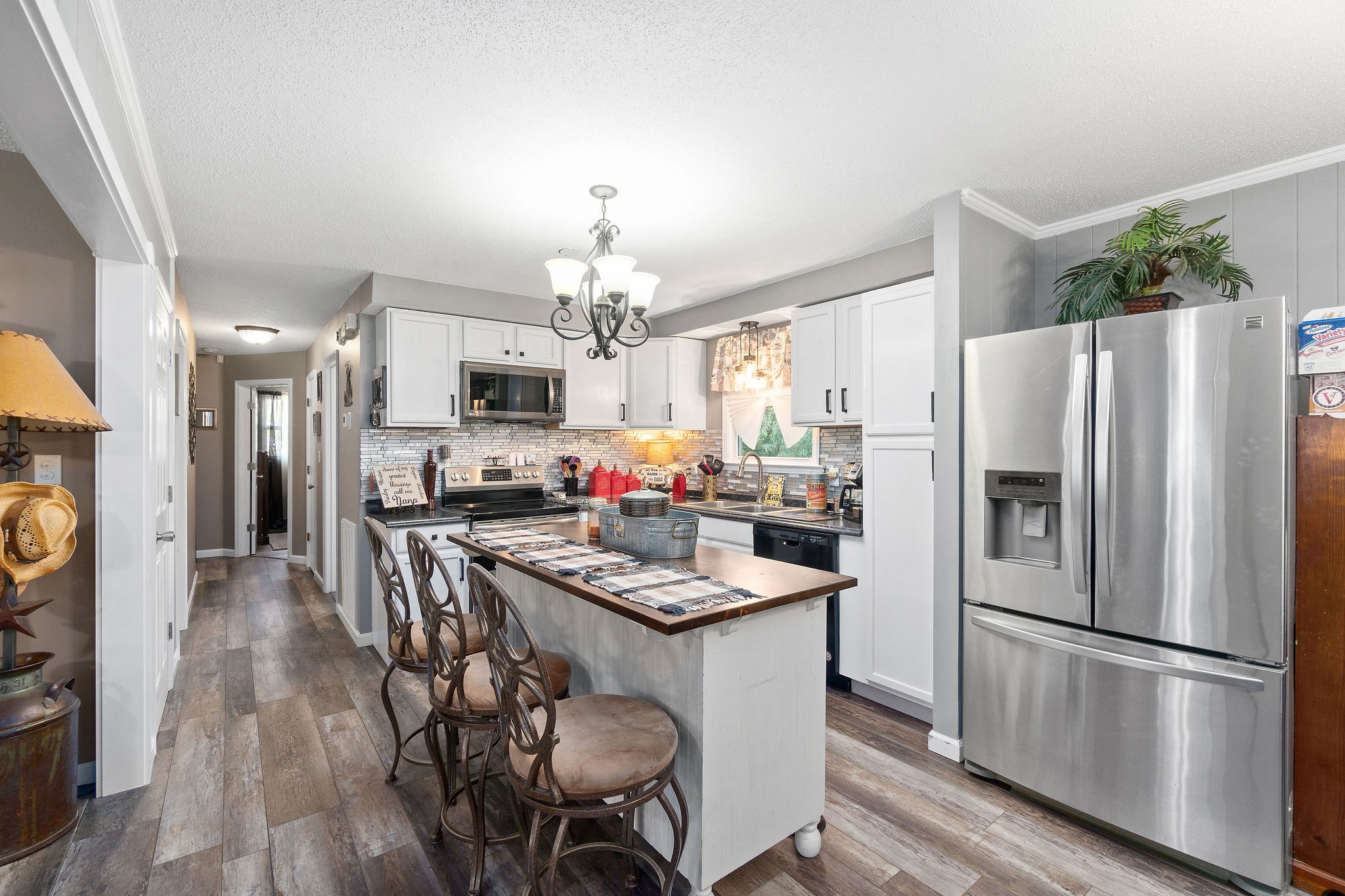 333 Dean Road Clarksville, TN 37040 - Photo 12 of 30 a kitchen with refrigerator a sink dining table and chairs