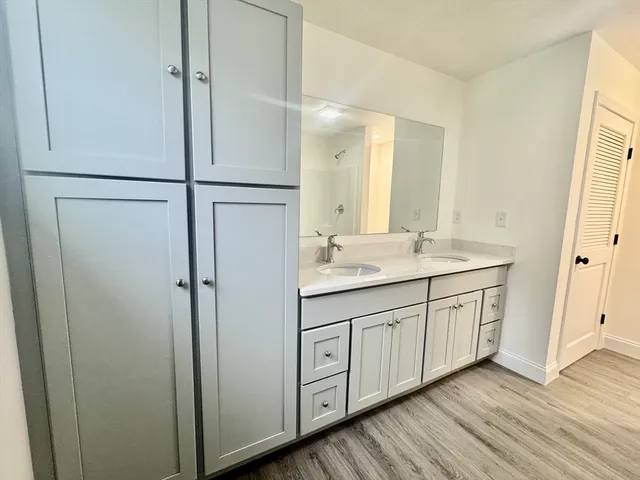 a bathroom with a double vanity sink and mirror