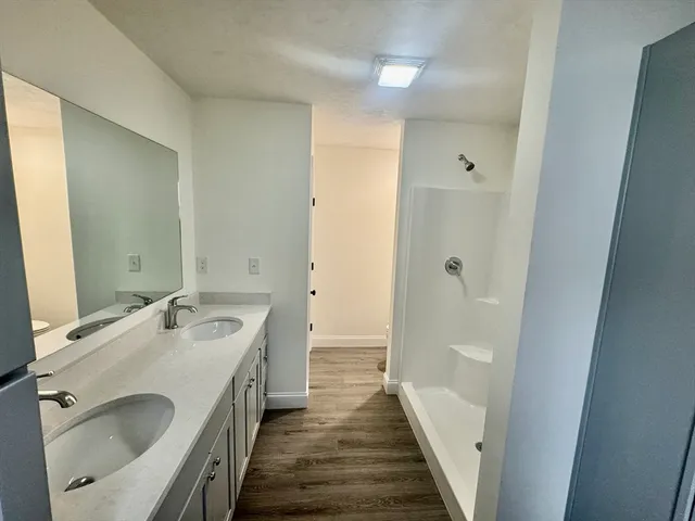 a bathroom with a double vanity sink and a mirror