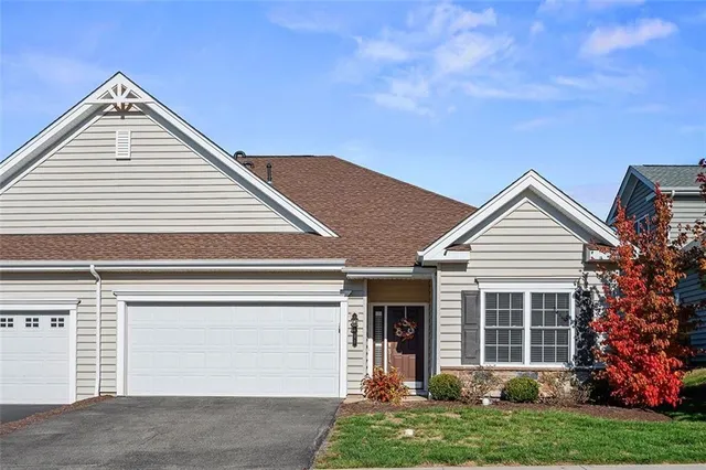 a view of a house with a yard and plants