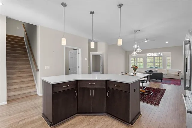 a kitchen with a sink a counter space appliances and cabinets