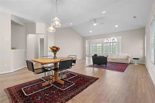 a living room with furniture a rug and a table