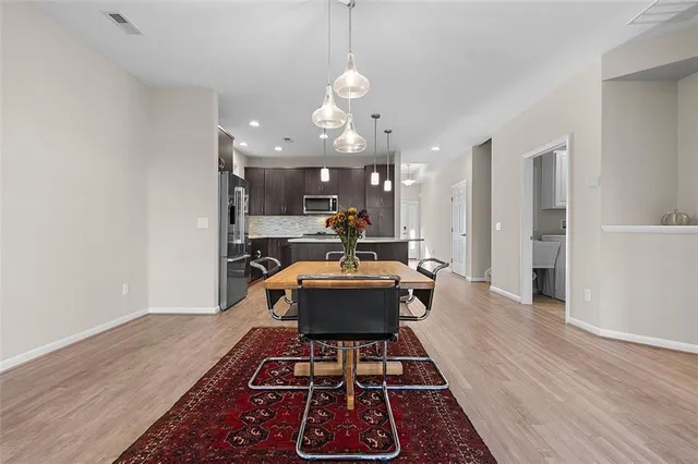 a kitchen with a table and chairs