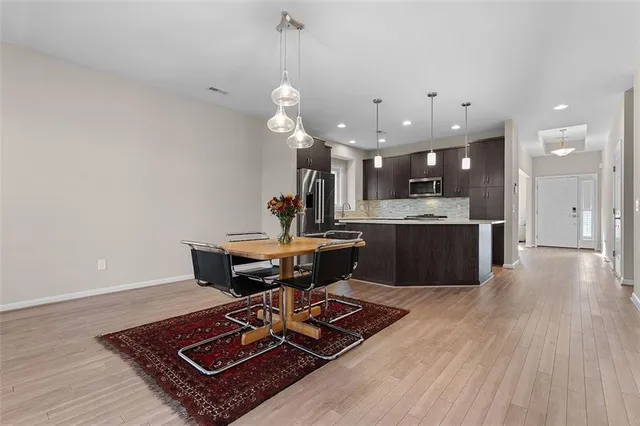 a living room with kitchen island furniture and wooden floor