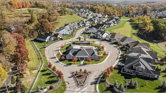 an aerial view of a swimming pool with outdoor seating and city view